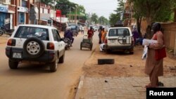 A man stands on a sidewalk, as vehicles move on a street in Niamey, Niger, Aug. 2, 2023. Niger is a key US partner in fighting Islamic extremism in the Sahel.