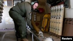 A crew member of a Royal Canadian Air Force CP-140 Aurora maritime surveillance aircraft drops sonar buoys in a search for the missing OceanGate submersible in the Atlantic Ocean June 20, 2023. (Canadian Forces/Handout via Reuters)
