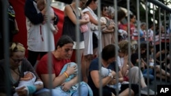 Relatives and supporters of Israeli hostages held by Hamas in the Gaza Strip hold baby dolls during a performance marking nine months since the start of the war and calling for their return, in Tel Aviv, Israel, July 7, 2024.