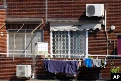 Air conditioning external units are seen on the facade of a building in Rome, July 25, 2023.