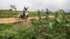 FILE - A man carries sacks of harvested maize on his motorbike from a farm in Masaka Karu area of Nasarawa state, Nigeria, Sep. 1, 2022.