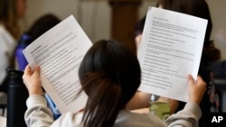 Jenes Ochoa Rojas goes over the lines of a three-scene play written by ChatGPT in Donnie Piercey's class at Stonewall Elementary in Lexington, Ky., Monday, Feb. 6, 2023.  (AP Photo/Timothy D. Easley)