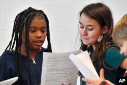 Kimaya Johnson, left, and Bella Whitice go over their lines of a play written by ChatGPT in Donnie Piercey's class at Stonewall Elementary in Lexington, Ky., Monday, Feb. 6, 2023.