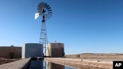 FILE - A windmill draws water for livestock in Leupp, Ariz., on the Navajo Nation, March 9, 2024.