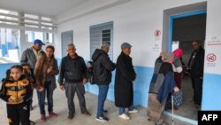 Voters queue outside a polling station during the 2023 local elections in the locality of Mnihla in Ariana province on the outskirts of Tunis on Dec. 24, 2023.