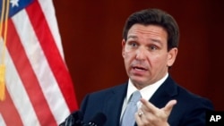 FILE - Florida Gov. Ron DeSantis speaks to the media at the state capitol in Tallahassee, March 7, 2023. DeSantis signed a bill March 25, 2024, that bans social media accounts for children under 14 and requires parental permission for 15- and 16-year-olds.