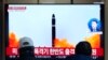 A TV screen shows a file image of North Korea's missile launch during a news program at the Seoul Railway Station in Seoul, South Korea, Feb. 20, 2023. 