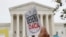 FILE - People rally outside the US Supreme Court over President Donald Trump's decision to end the Deferred Action for Childhood Arrivals program (DACA), at the Supreme Court in Washington, Nov. 12, 2019. 