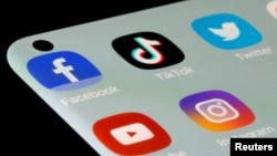 FILE - Social media apps are seen on a smartphone in this illustration taken, July 13, 2021. Florida Governor Ron DeSantis on Monday signed a law that bans children in the state under the age of 14 from having a social media account. (REUTERS/Dado Ruvic/Illustration/File Photo)