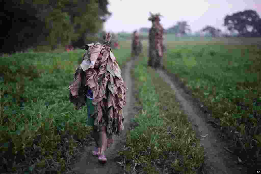 A Catholic boy walks towards the church of Saint John the Baptist during the mud festival at Bibiclat, Nueva Ecija province, northern Philippines.