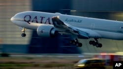 FILE - A Qatar airways plane lands at the airport in Frankfurt, Germany, as the sun rises, Sept. 25, 2023. 