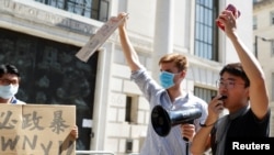 FILE - Former British Consulate employee Simon Cheng speaks during a protest against Hong Kong's deteriorating freedoms outside China's embassy, in London, July 31, 2020.