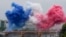 Ceremonial smoke in the colors of the France flag appear over the Seine River in Paris, during the opening ceremony of the 2024 Summer Olympics, July 26, 2024.