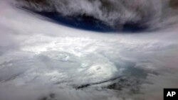 In this photo released by Hong Kong's Information Services Department, Typhoon Saola is seen from a Challenger 605 fixed-wing aircraft near Hong Kong on Sept. 1, 2023.