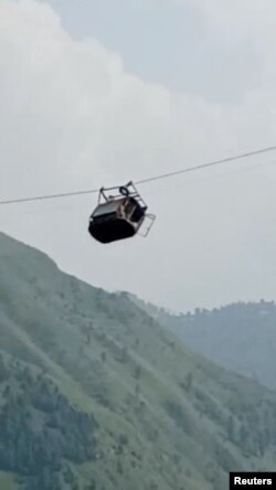 A view shows cable car carrying students stranded mid-air in Battagram, Pakistan, Aug. 22, 2023, in this screen grab obtained from social media video. (Umeed Sahar/via REUTERS)