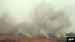 FILE - Smoke billows over hills in the Israeli-annexed Golan Heights after rockets were fired from the Lebanese side of the border, July 3, 2024.