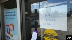 A "NO POWER" sign tells customers why a Walgreens store in Detroit, Michigan, is closed on Feb. 24, 2023. The state is shivering through extended power outages caused by one of the worst ice storms in decades.