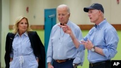 President Joe Biden and first lady Jill Biden listen as Sen. Rick Scott, R-Fla., speaks at Suwannee Pineview Elementary School, Sept. 2, 2023, in Live Oak, Fla.