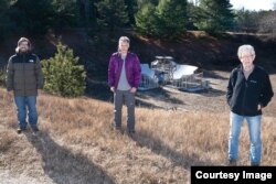 Anže Slosar, Sven Herrmann, and Paul O'Connor (pictured left to right) stand in front of BMX, the prototype radio telescope that was developed at Brookhaven. (Image Credit: Brookhaven National Laboratory)