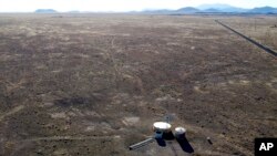 FILE - A windmill draws water for livestock in Leupp, Ariz., on the Navajo Nation, March 9, 2024.