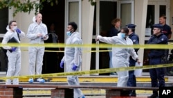 French police officers from the forensic service stand in front of the Gambetta high school in Arras after a man armed with a knife killed a teacher Oct. 13, 2023. 