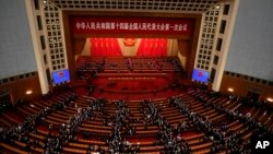 Delegates leave after the opening session of China's National People's Congress (NPC) at the Great Hall of the People in Beijing, March 5, 2023.