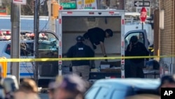 Members of the NYPD bomb squad examine a rental truck that was stopped and the driver arrested, in New York, Feb. 13, 2023.