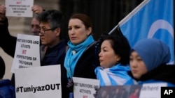 Activists and community members hold a small protest outside the British Foreign Office in central London, Monday, Feb. 13, 2023. 