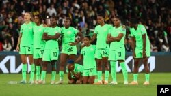 Nigeria's players hug during a penalty shootout during the Women's World Cup round of 16 soccer match between England and Nigeria in Brisbane, Australia, Aug. 7, 2023. Nigeria forward Uchenna Kanu said money was not the team's main motivation — playing well was.