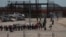 FILE - Migrants line up after being detained by U.S. authorities at the U.S.-Mexico border in Ciudad Juarez, Mexico, April 30, 2023. 