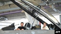 Predsednik Ukraine Volodimir Zelenski i danska premijerka Mete Frederisken sede u kabini borbenog aviona F-16, u hangaru u vazdušnoj bazi Skridstrup u severnoj Danskog, 20. avgusta 2023.