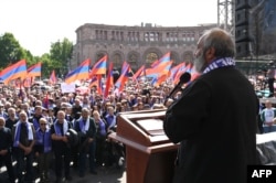 Protest leader Archbishop Bagrat Galstanyan addresses demonstrators during a rally to demand Prime Minister Nikol Pashinyan's resignation over land transfer to neighbouring Azerbaijan, at the central Republic Square in Yerevan, May 26, 2024.