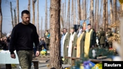 Ukraine's President Volodymyr Zelenskyy attends a commemorative ceremony for Ukrainian servicemen killed in the battle for the village of Moshchun, in Kyiv region, Ukraine, March 21, 2024. (Ukrainian Presidential Press Service via Reuters)