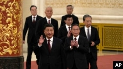 FILE - New members of the Politburo Standing Committee — front to back, President Xi Jinping, Li Qiang, Zhao Leji, Wang Huning, Cai Qi, Ding Xuexiang and Li Xi — in Beijing, Oct. 23, 2022. Some observers say that Xi, Li Qiang and Cai are China's new "Gang of Three."