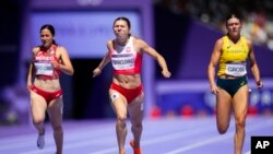 Krystsina Tsimanouskaya, center, of Poland, competes in the women's 200-meter repechage at the 2024 Summer Olympics, Aug. 5, 2024, in Saint-Denis, France.