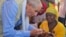 UNICEF representative Gianfranco Rotigliano gives oral vaccine to a child during the launch of the nationwide typhoid vaccination campaign, May 11, 2023, in Malawi's Balaka district. (UNICEF Malawi)