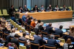 Illia Samoilenko, a Ukrainian soldier who fought in Mariupol and former prisoner of war, speaks at United Nations headquarters, Feb. 22, 2023. He is seated third from the left at the table on the podium.