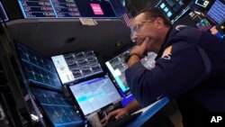 Specialist Anthony Matesic works at his post on the floor of the New York Stock Exchange, Aug. 5, 2024.