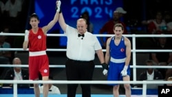 Taiwan's Lin Yu-ting, left, celebrates after defeating Turkey's Esra Yildiz in their women's 57 kg semifinal boxing match at the 2024 Summer Olympics, Aug. 7, 2024, in Paris.
