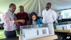 Britain's Home Secretary Suella Braverman, Rwanda Infrastructure Minister Ernest Nsabimana, and Kigali Mayor Pudence Rubingisa inspect a project, Kigali, Rwanda, March 19, 2023.