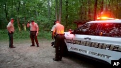Authorities secure the entrance to Mine Bank Trail, an access point to the rescue operation along the Blue Ridge Parkway where a Cessna Citation crashed over mountainous terrain near Montebello, Va., June 4, 2023. (Randall K. Wolf via AP)
