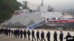 Navy soldiers walk past a Taiwan-made corvette warship during the inauguration ceremony in Yilan on March 26, 2024. 