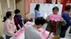 FILE - Polling officers count votes in New Taipei City, Taiwan, Jan. 13, 2024.