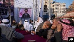 Palestinians watch a pre-recorded speech by Iranian President Ebrahim Raisi on "Jerusalem Day," which is called al-Quds Day after the city's Arabic name, at a soccer field in Gaza City, April 14, 2023.