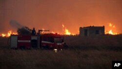 A firefighter operates during a wildfire near the northeastern town of Alexandroupolis, Greece, Aug. 20, 2023. 