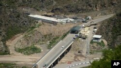FILE - A bridge and a checkpoint are seen on a road towards the separatist region of Nagorno-Karabakh in Armenia, July 28, 2023. 