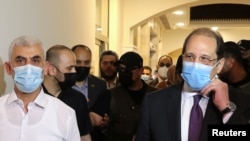 FILE - Palestinian Hamas Gaza Chief Yehya Al-Sinwar and head of the Egyptian general intelligence Abbas Kamel walk as they meet in Gaza, May 31, 2021. Kamel is leading a delegation to Israel on April 26, 2024, to discuss a cease-fire in Gaza.