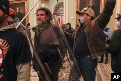 FILE - Rioters, including Dominic Pezzola, center with police shield, are confronted by U.S. Capitol Police officers in the Capitol in Washington, Jan. 6, 2021. Pezzola, a former member of the far-right Proud Boys, was sentenced to 10 years in prison.