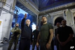 FILE - In this photo provided by the Ukrainian Presidential Press Office, Ukrainian President Volodymyr Zelenskyy, center right, inspects damage of the Odesa Transfiguration Cathedral in Odesa on July 27, 2023.