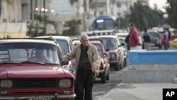 FILE - People wait in line to refuel their cars in Havana, Cuba, Feb. 2, 2024.
